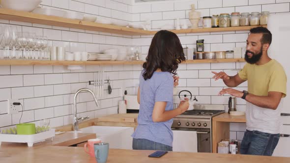 Happy couple dancing together in the kitchen