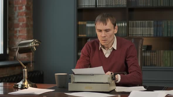 Male Writer Typing on Vintage Writing Machine