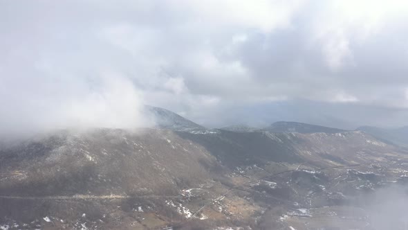 Fog and clouds over the mountain top 4K aerial footage