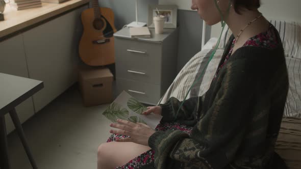 Girl Looking at Drawing in Hospital Ward