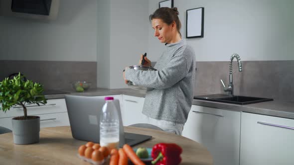 Woman Looking Recipe Online While Cooking