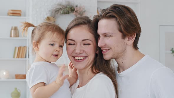 Portrait Caucasian Family Young Mother Millennial Father Loving Parents Hold Little Girl Child
