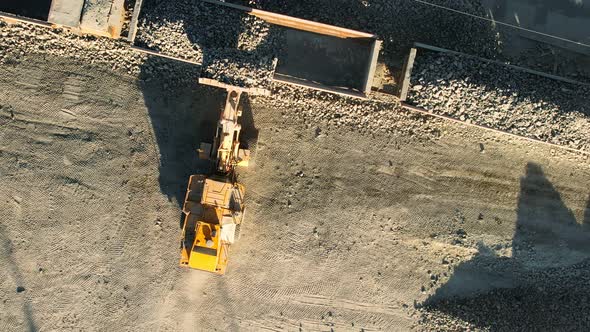 Aerial Top View Wheel Loader Loads Rock Into the Wagons of the Train