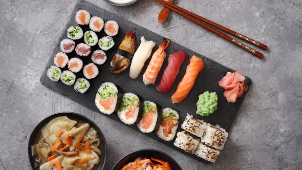 Various Kinds of Sushi Placed on Black Stone Board