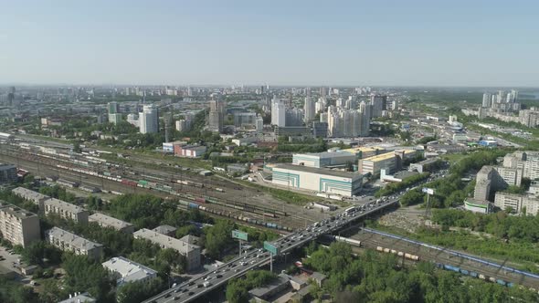 Aerial view of Rail Station with freight trains and road junction in a big city 07