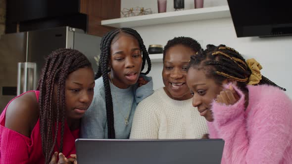 African Mom Watching Family Video with Daughters