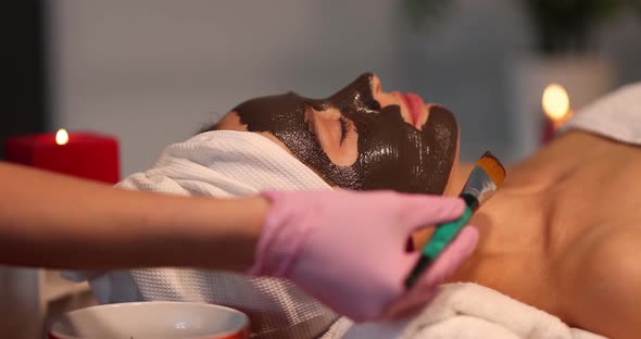 Woman with Mud Mask Lies in Spa and Does Rejuvenation Procedure