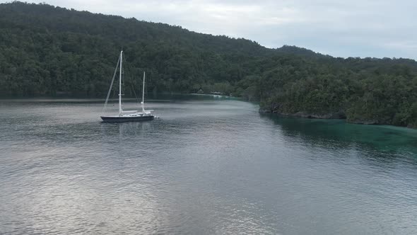 Aerial View Of Triton Bay: Boat On Turquoise Sea And Green Tropical Trees In Kaimana Islands. 