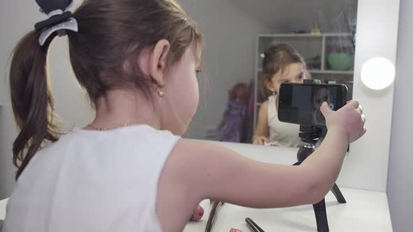 Brunette Girl Making Selfie at Home Using Tripod