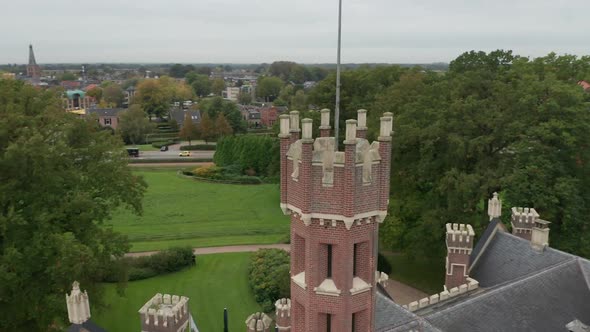 Aerial orbit of castle tower with battlements on top of a old castle