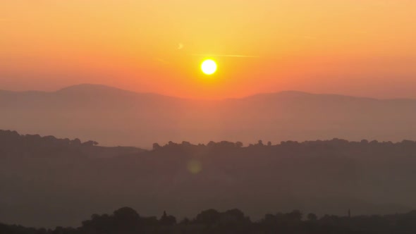 Sunrise Time Lapse Over Hills and Mountains