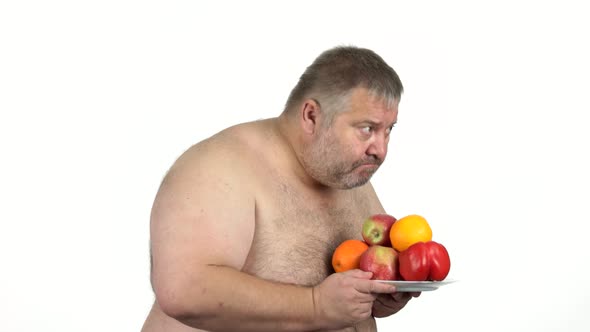 Fat Mature Man Holding Plate with Healthy Food