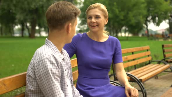 Caring Mother Spending Time With Her Teenage Son, Straighten Collar of His Shirt