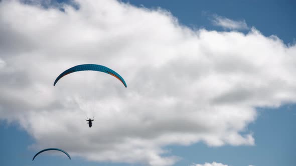 Paragliding against the cloudy sky