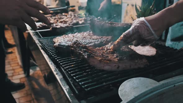 Meat Is Grilled at Street Food Festival. Large Pieces of Pork Roasted on the BBQ