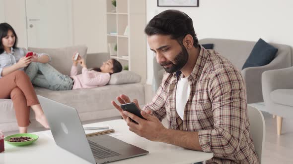 Family Father Sitting Working and Resting in Living Room at Home Office