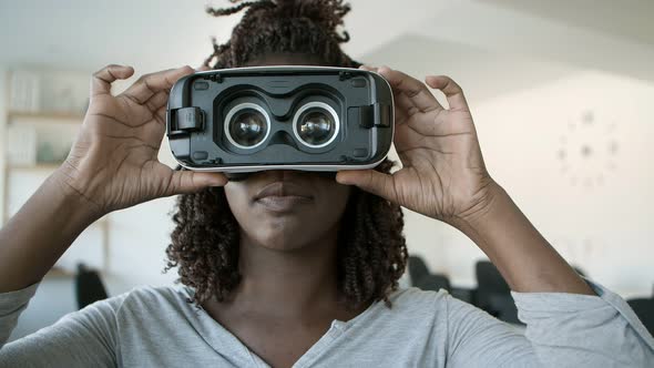 Cheerful African American Woman Experiencing VR Glasses