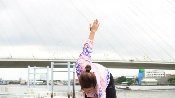 Young Woman Stretching Outdoors