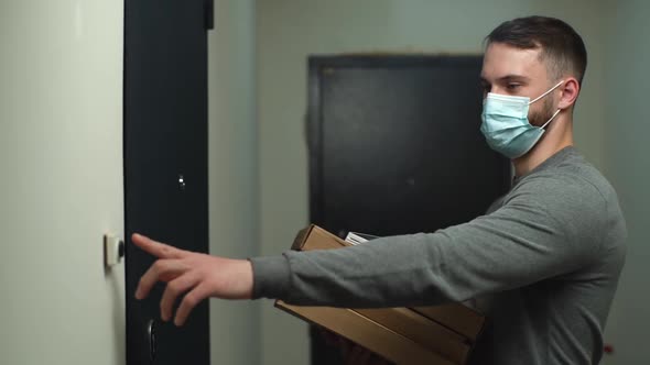 Courier in Medical Mask Coming To Door with Boxes with Hot Pizza and Rings Doorbell