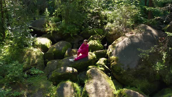 A Girl Practices Yoga in the Forest