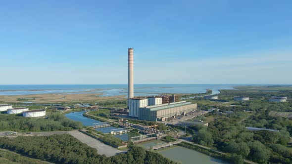 Aerial view of old thermoelectric plant with big chimne in a rural landscape