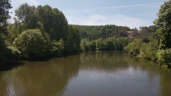 Calm expansive river in west Germany on a sunny spring morning. Wide angle flyover