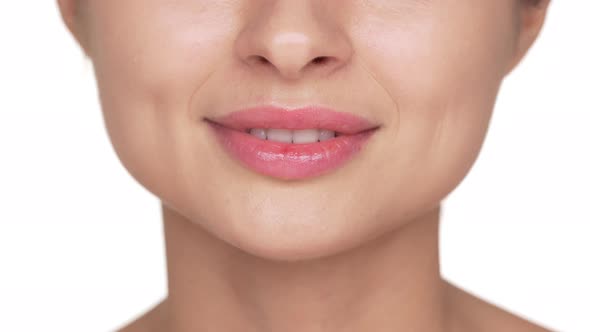 Extreme Closeup Portrait of Young Woman Wearing Light Fresh Lip Makeup Smiling Showing Her Healthy