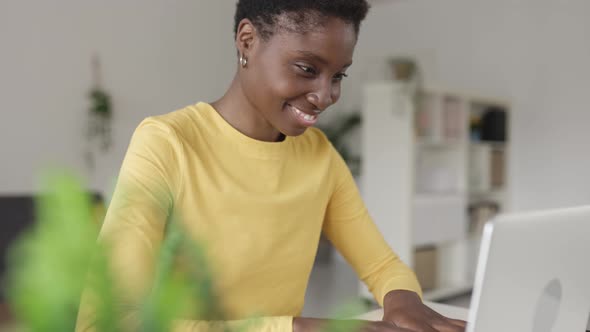 Young Happy African American Woman Working on Laptop From Home