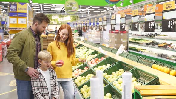 Portrait of Happy Family with Child Boy in Food Store