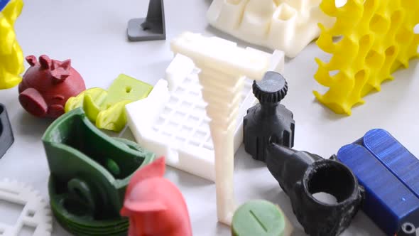 Many Bright Multicolored Objects Printed on 3d Printer Lie on Flat Surface