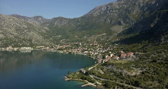 Aerial shot of Risan in Montenegro. ruins in the foreground on the bay of Kotor and mountains in the