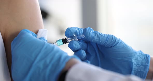 Nurse Making Vaccine Against Coronavirus Infection in Patient Shoulder Closeup  Movie