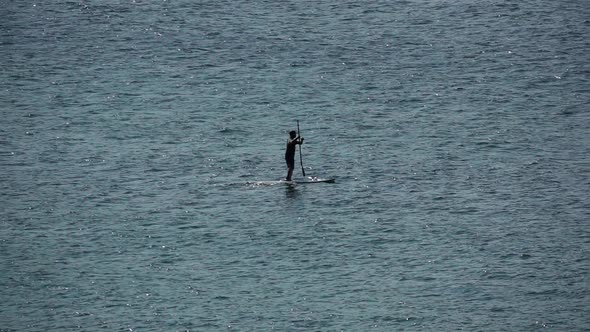 Unrecognizable Man in the Middle of the Ocean