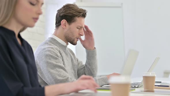 Tired Creative Female Professional Having Headache in Office