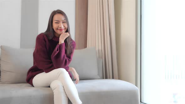 Asian woman sit on sofa and relax