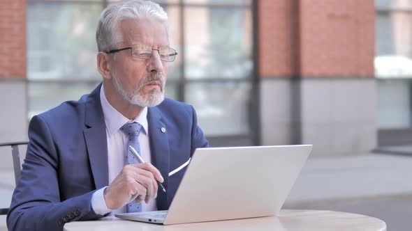 Old Businessman Working on Laptop Outdoor