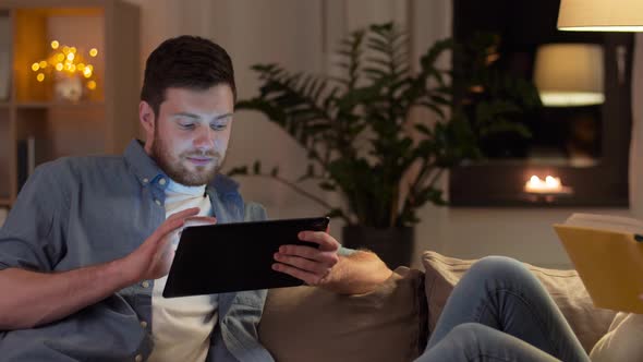 Couple with Tablet Computer and Book at Home 75