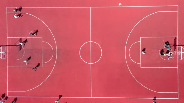 Aerial View of Young Athletes Playing Street Basketball on an Open Summer Playground