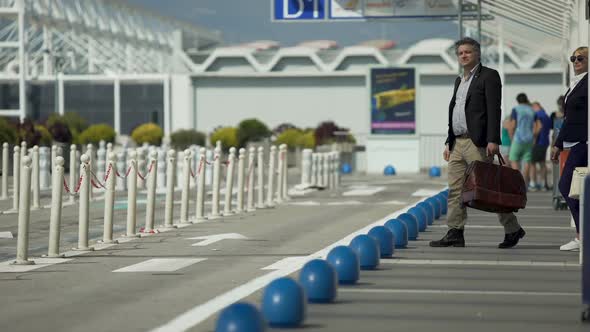 Business Trip, Man and Woman Hailing Taxi Near Airport, Traveling, Journey