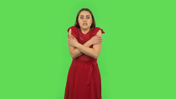 Tender Girl in Red Dress Girl Froze and Trying To Keep Warm. Green Screen