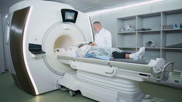 Magnetic Resonance Imaging in the Modern Hospital Adult Man Doctor Performs a Magnetic Tomographic