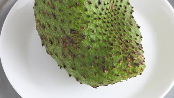 Closeup of Whole Green Soursop Graviola, Exotic, Tropical Fruit Guanabana on Plate