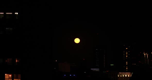 Moon rises over city