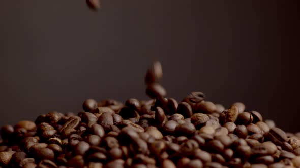 Coffee Beans Falling Down on Heap Close Up