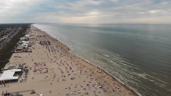 Aerial footage of a crowded beach along a North Sea resort near Zandoort, Netherlands.