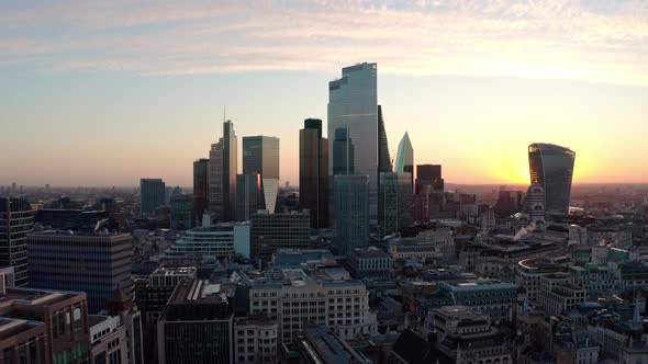 flying towards Central London skyscraper buildings at sunrise close up