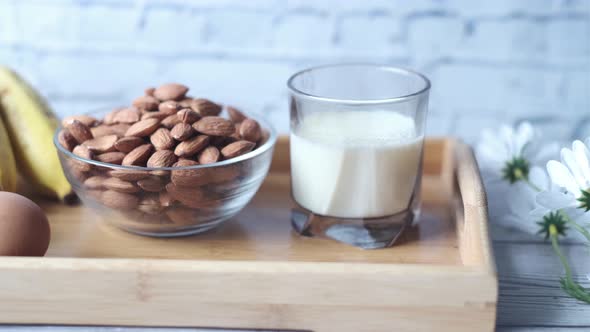 Eggs in a Plastic Container Milk and Almond Nut in Table