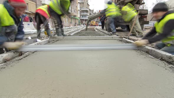 Pouring Readymixed Concrete After Placing Steel Reinforcement to Make the Road By Concrete Mixer