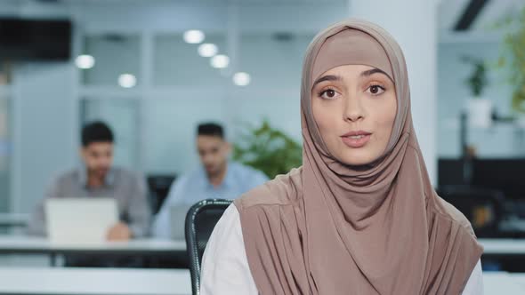 Smiling Arab Female Business Leader Introducing Great Team in Office