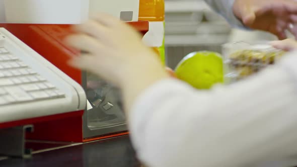 Cashier Scanning Items in Supermarket